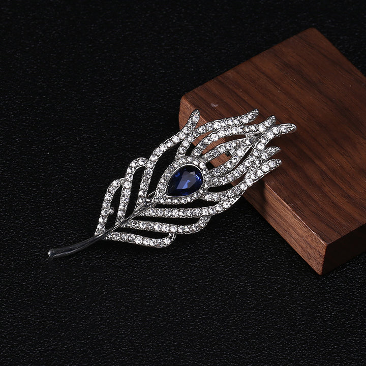 Women’s Rhinestone Feather Brooch | بروش نسائي مرصع بتصميم ريشة أنيقة