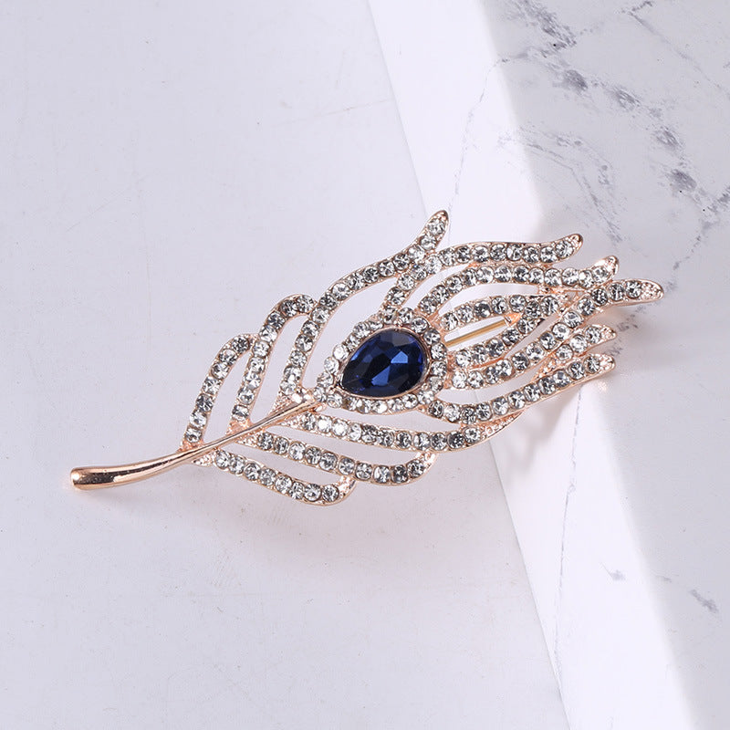 Women’s Rhinestone Feather Brooch | بروش نسائي مرصع بتصميم ريشة أنيقة